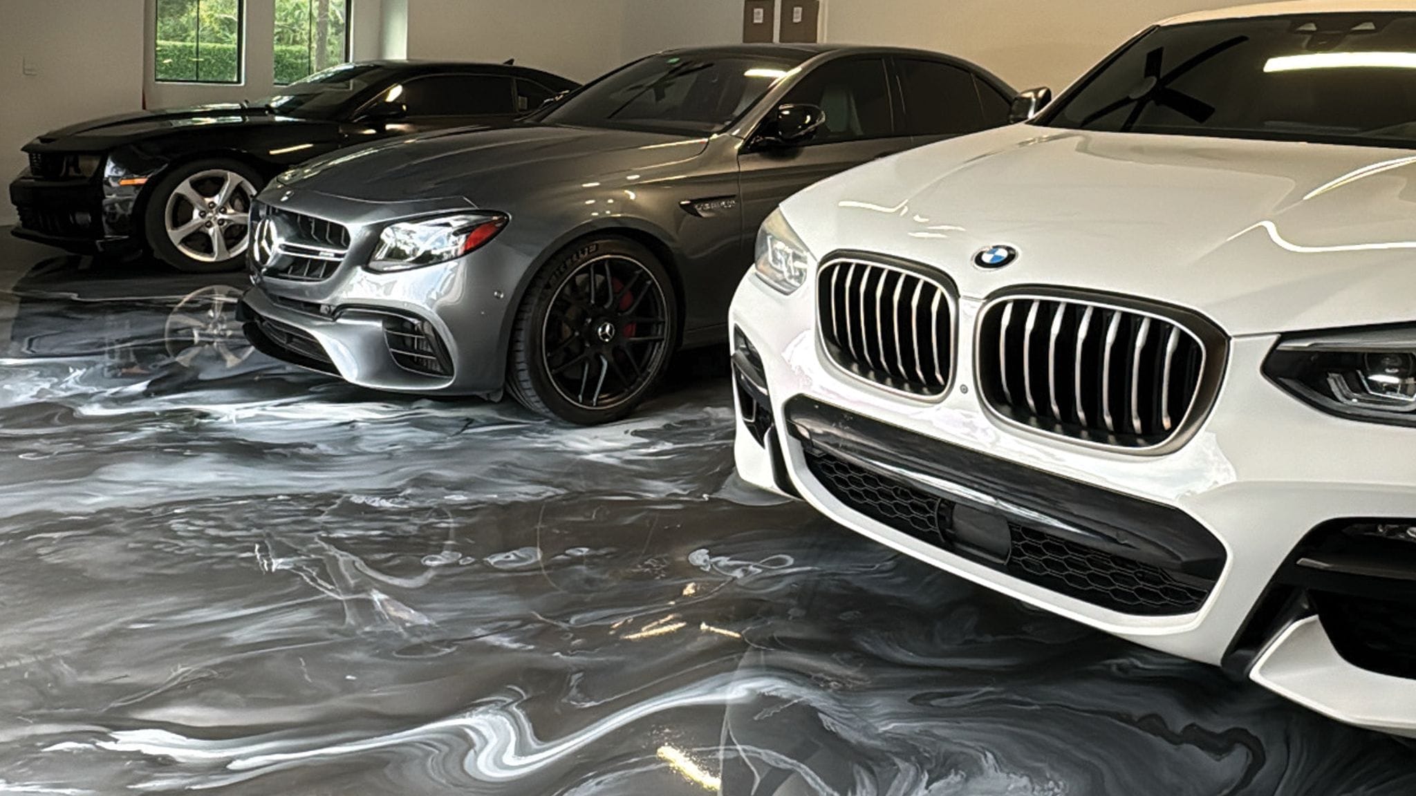 Decorative metallic epoxy floor with a marbled finish in a residential garage living space in Southwest Florida