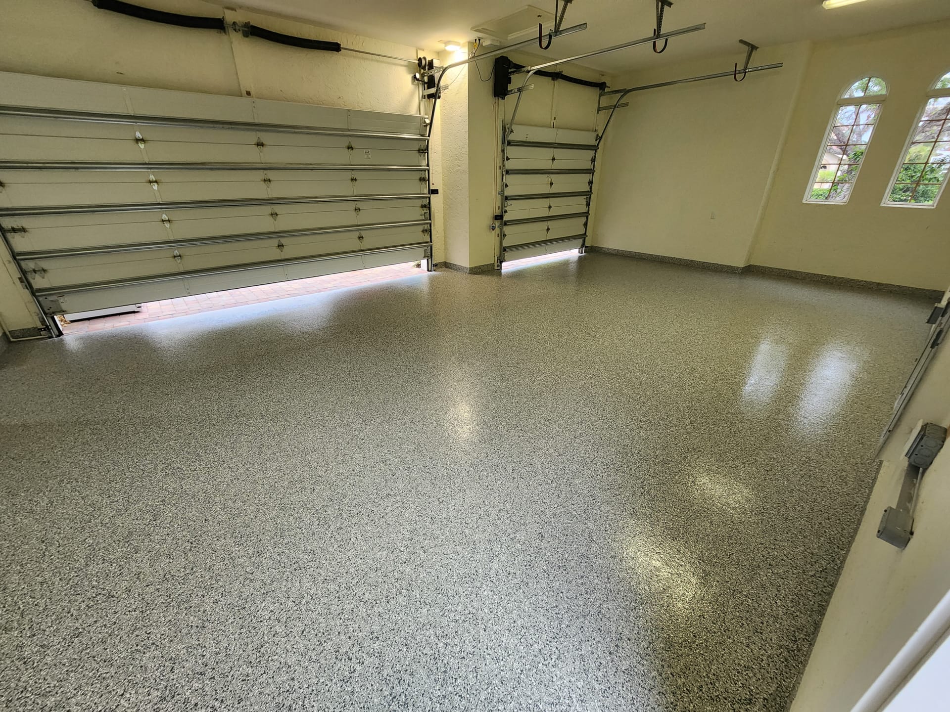 Alt Text: Freshly installed epoxy garage flooring in a Naples, Florida home.