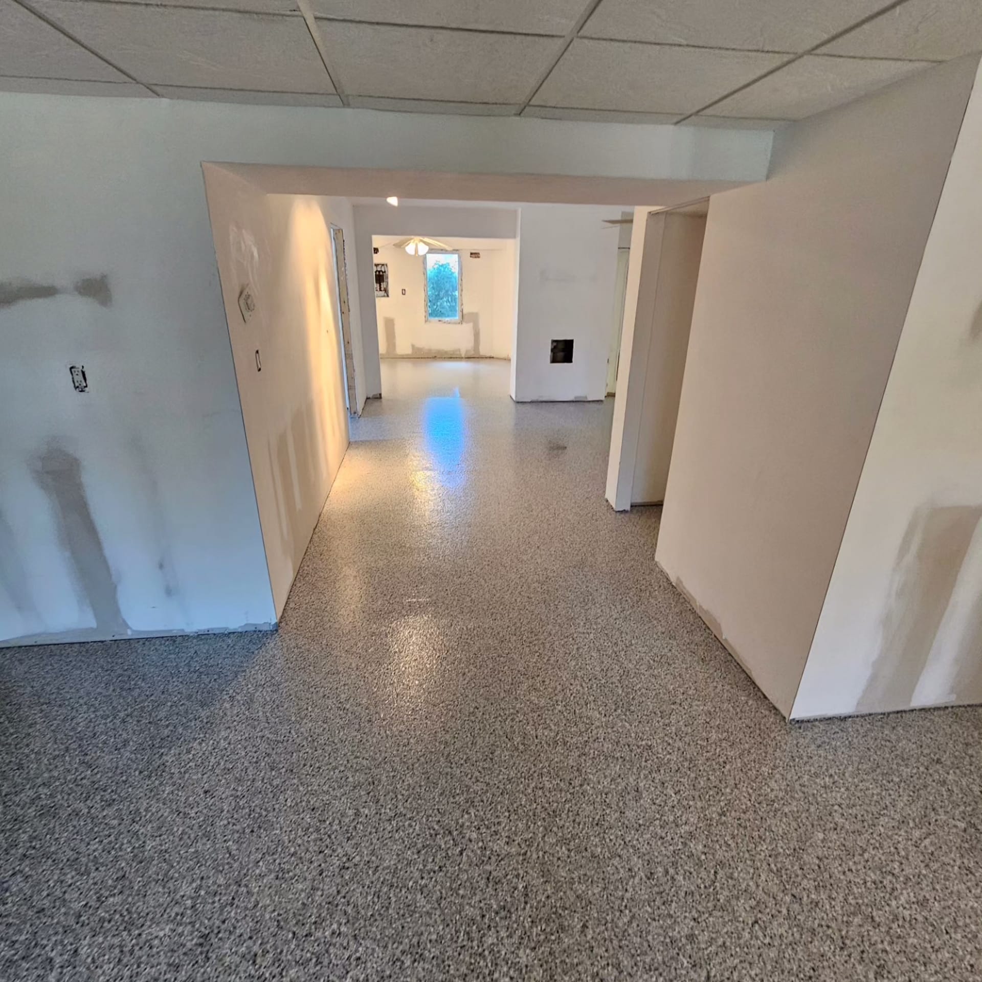 Epoxy floor installation in a Fort Myers, FL home with a high-gloss, durable finish.