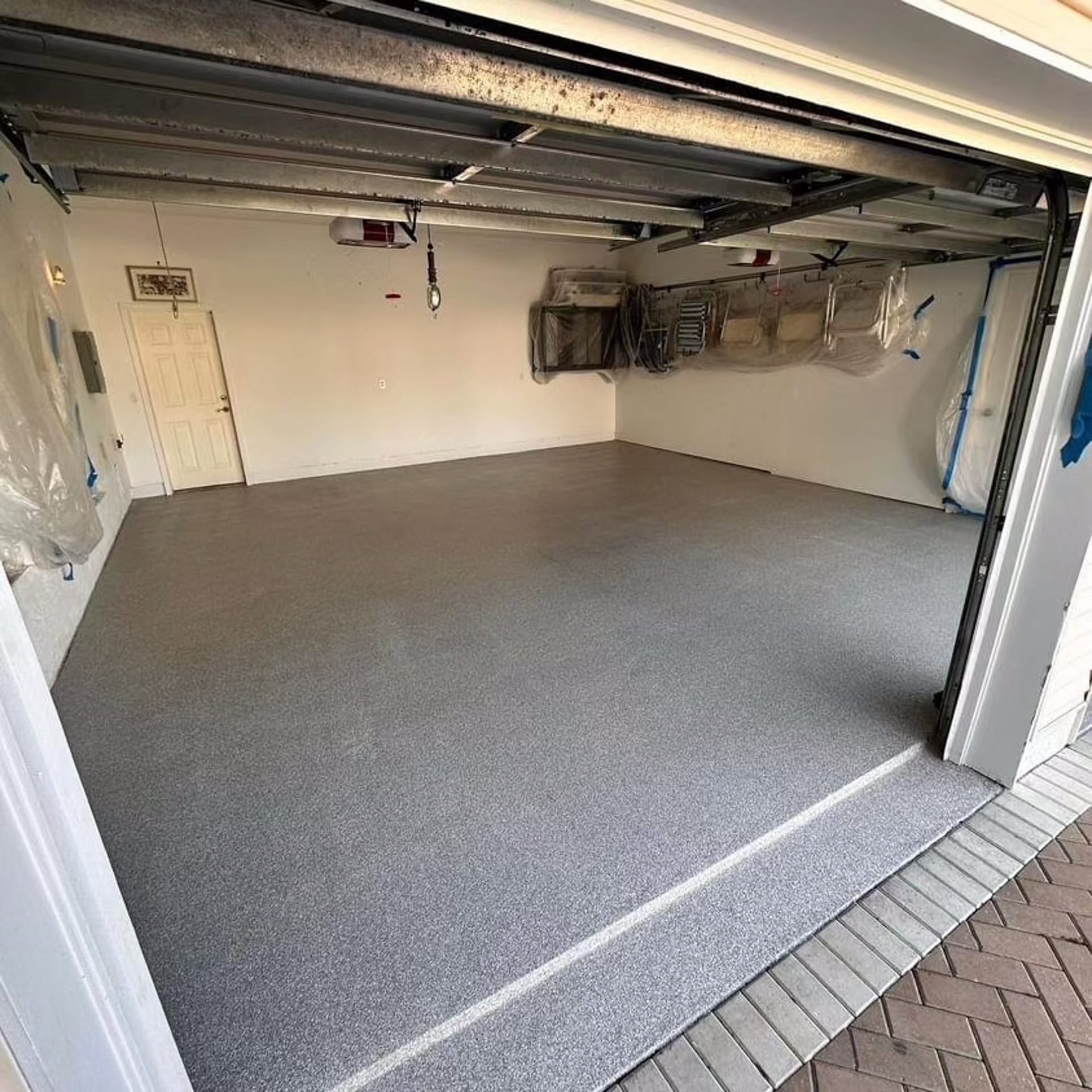 Epoxy-coated garage floor installation in Marco Island, FL, by Top Quality Coating – showcasing a sleek high-gloss finish.
