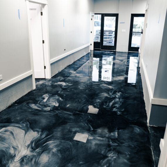 Metallic epoxy floor with a glossy 3D marble effect in a luxury Naples, FL residence.